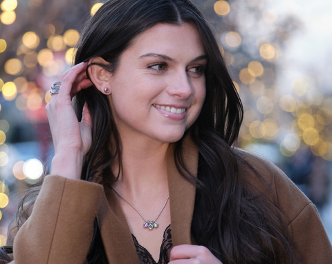 woman wearing birthstone necklace as a wedding party gift