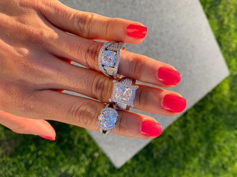 woman showing off diamond statement rings