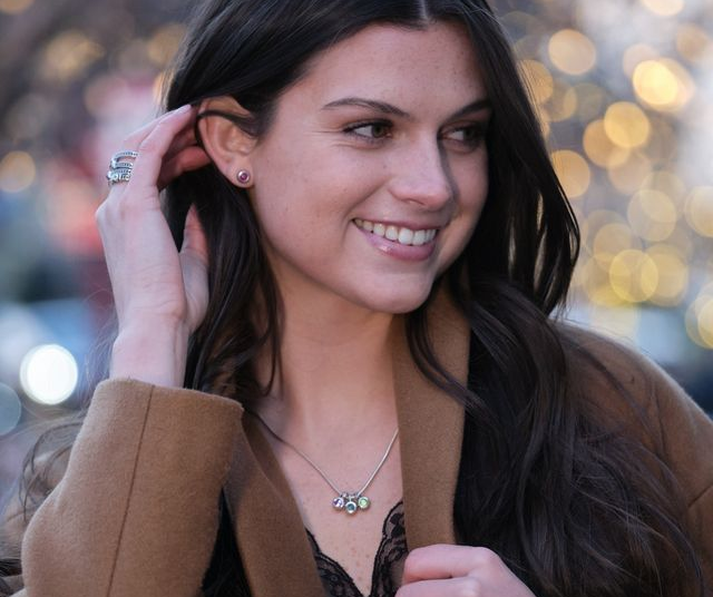 woman wearing mothers day trending heart and angel pendants