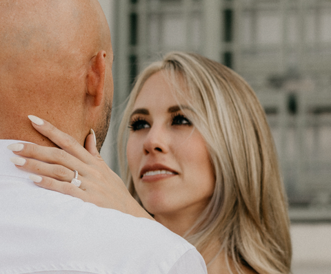 a woman being proposed to with a custom engagement ring over the holiday season