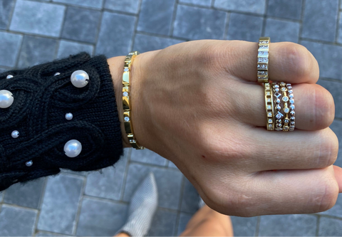 woman showing off diamond stacking rings and stacking ring styles