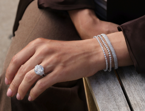 a woman wearing a mix of lab grown and natural diamond jewelry